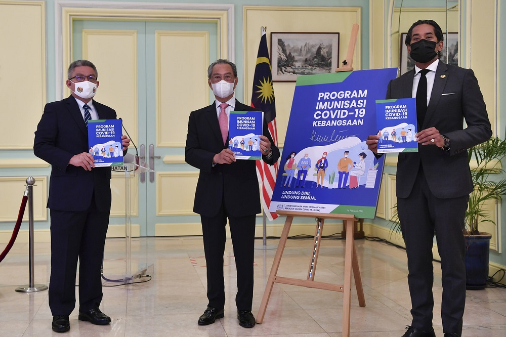 Prime Minister Tan Sri Muhyiddin Yassin (centre) at the launch of the National Covid-19 Immunisation Programme Handbook at the Perdana Putra Building in Putrajaya February 16, 2021. — Bernama pic