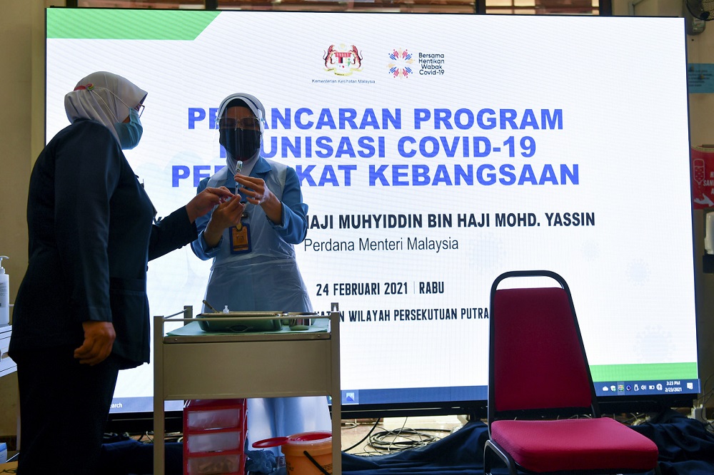 Health workers are seen during a simulation exercise for the National Covid-19 Immunisation Programme, at the Health Ministry in Putrajaya February 23, 2021. u00e2u20acu201d Bernama pic