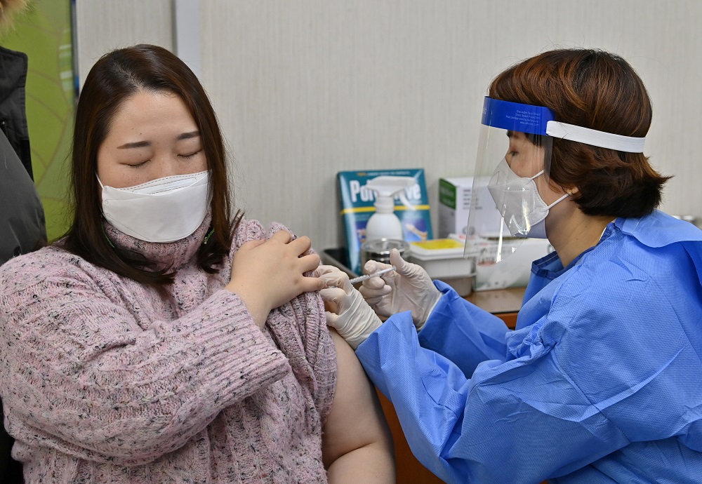 A nursing home worker (left) receives the first dose of the AstraZeneca Covid-19 vaccine at a health care centre in Seoul February 26, 2021. u00e2u20acu2022 Pool via Reuters