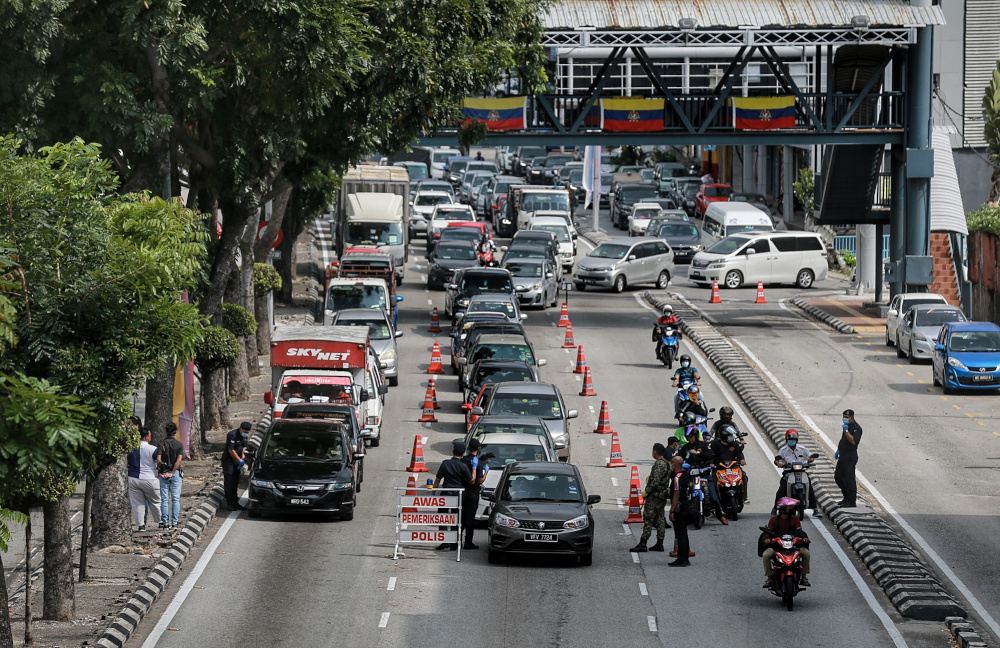 Police personnel conduct a roadblock at Jalan Loke Yew during MCO 2.0, February 19, 2021. u00e2u20acu201d Picture by Ahmad Zamzahuri