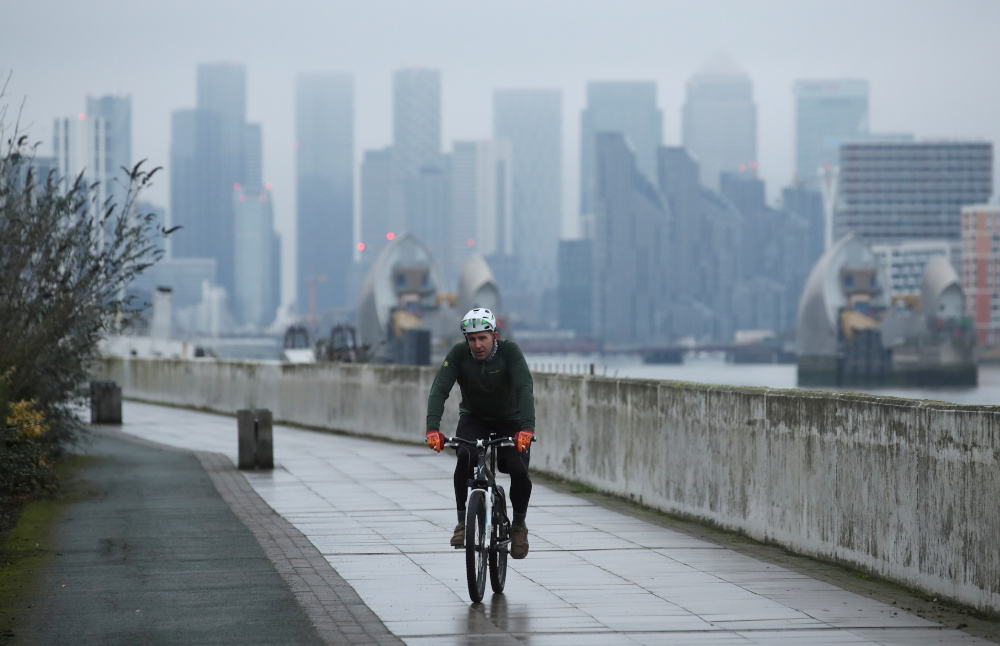 Buildings are seen in the Canary Wharf business district, as a man cycles along a path, amid the outbreak of the coronavirus disease in London, Britain January 27, 2021. u00e2u20acu201d Reuters pic 