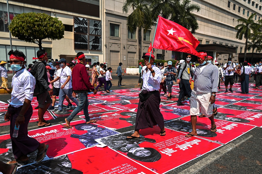 People step on placards showing the photo of an alleged Myanmar Army sniper during a protest against the military coup in Yangon February 22, 2021. u00e2u20acu2022 Reuters pic