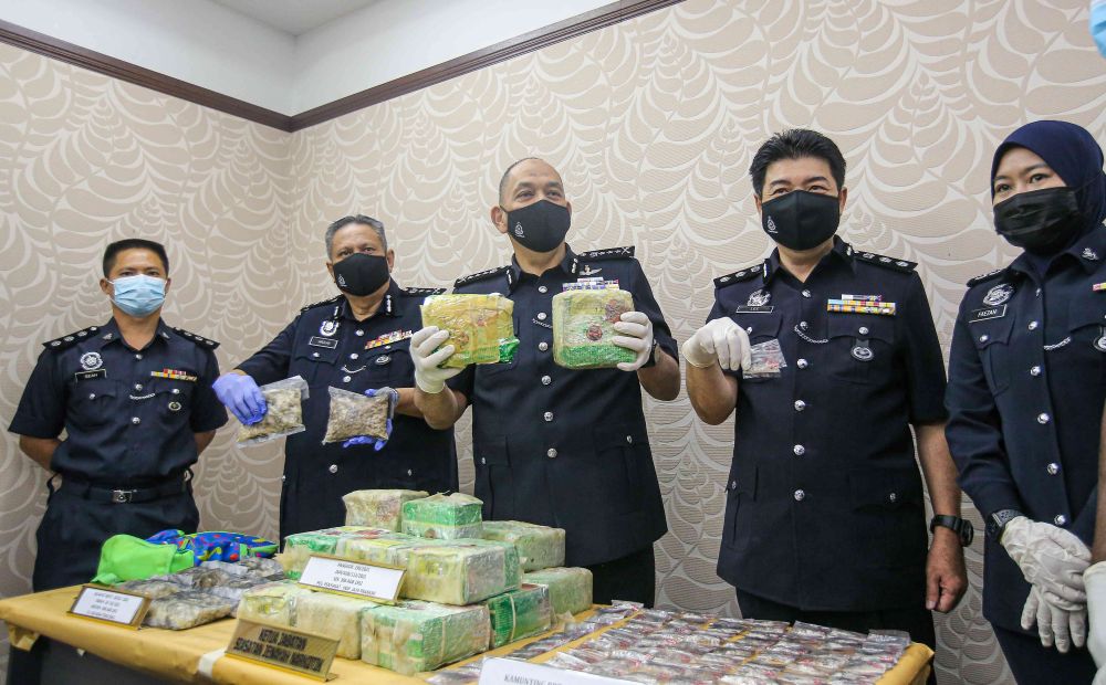 Perak police chief commissioner Datuk Mior Faridalathrash Wahid holds up drugs seized at the state police headquarters in Ipoh February 26, 2021. u00e2u20acu201d Picture by Farhan Najib
