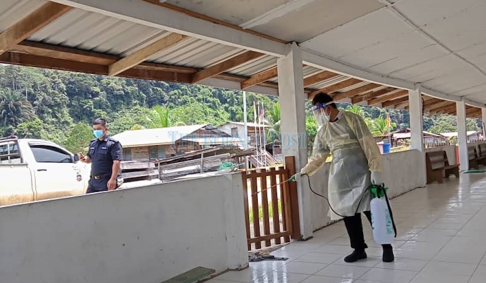 Medical personnel sanitising a section of a longhouse during the height of the Covid-19 pandemic in Sarawak in this file photo. u00e2u20acu201d Photo courtesy of Borneo Postnn