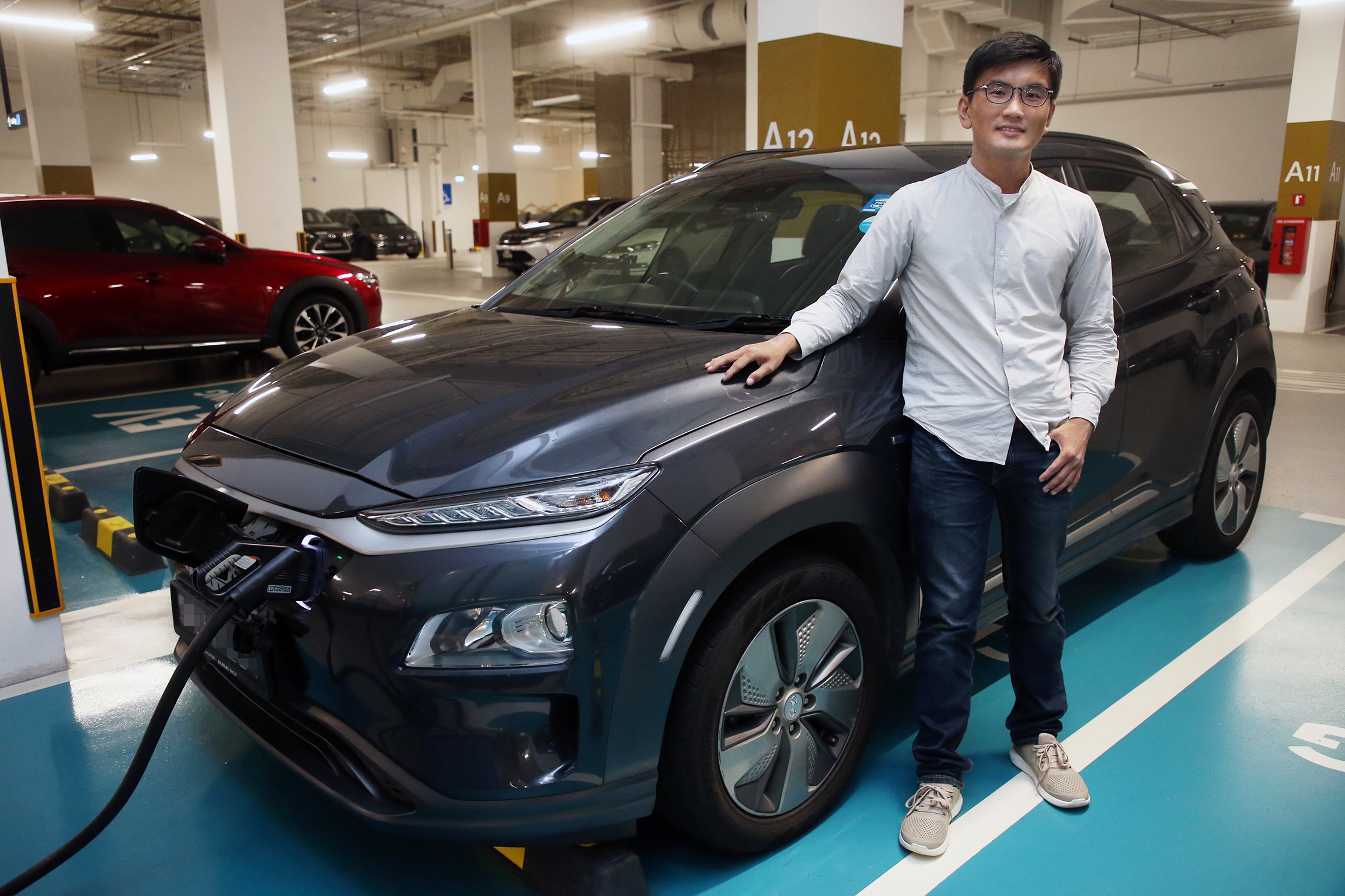 Mr Koh Jie Meng, who has been driving an electric vehicle (EV) since 2019, said he now has no doubts about the feasibility of owning one, even as a HDB dweller. — Photo by Ooi Boon Keong for TODAY
