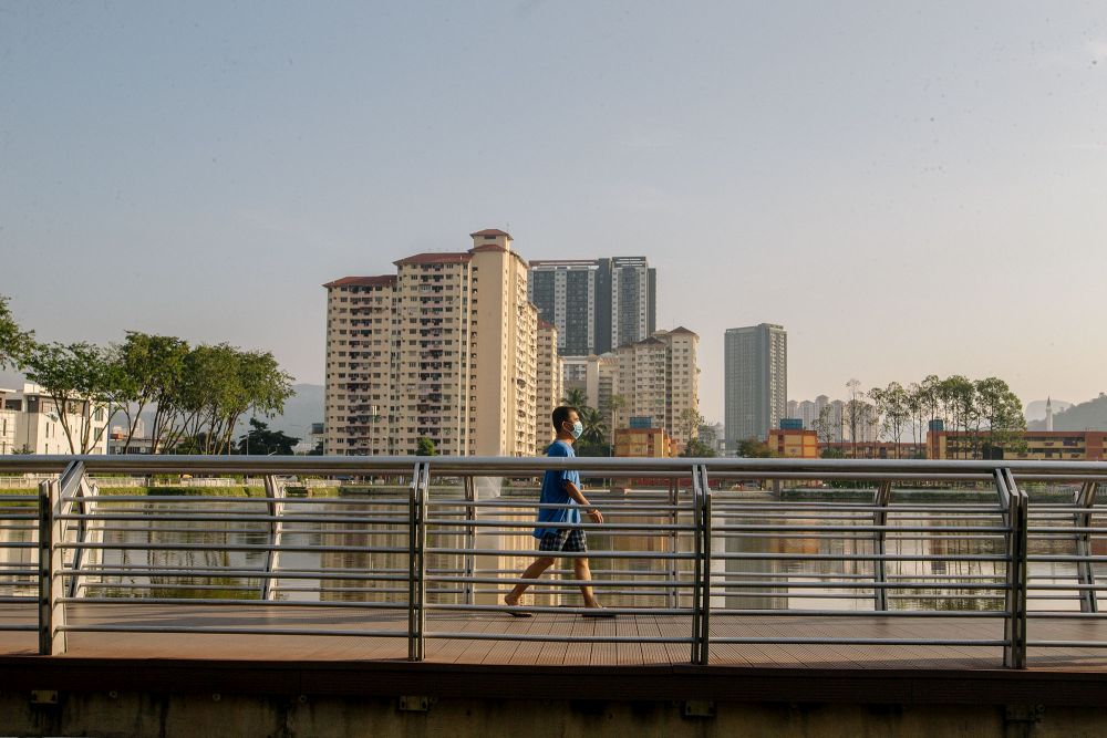 A man is seen taking a walk at the Sri Rampai Lake Park in Kuala Lumpur February 24, 2021. u00e2u20acu201d Picture by Firdaus Latifnn