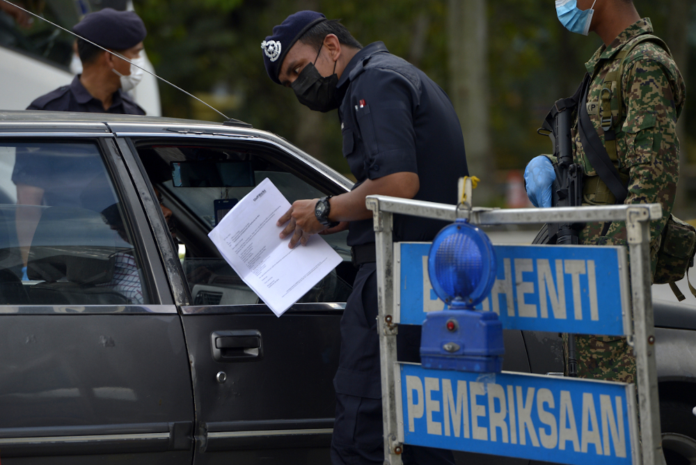 Police conduct roadblock checks during movement control order 2.0 (MCO) in Subang Jaya, February 2, 2021. — Picture by Miera Zulyana