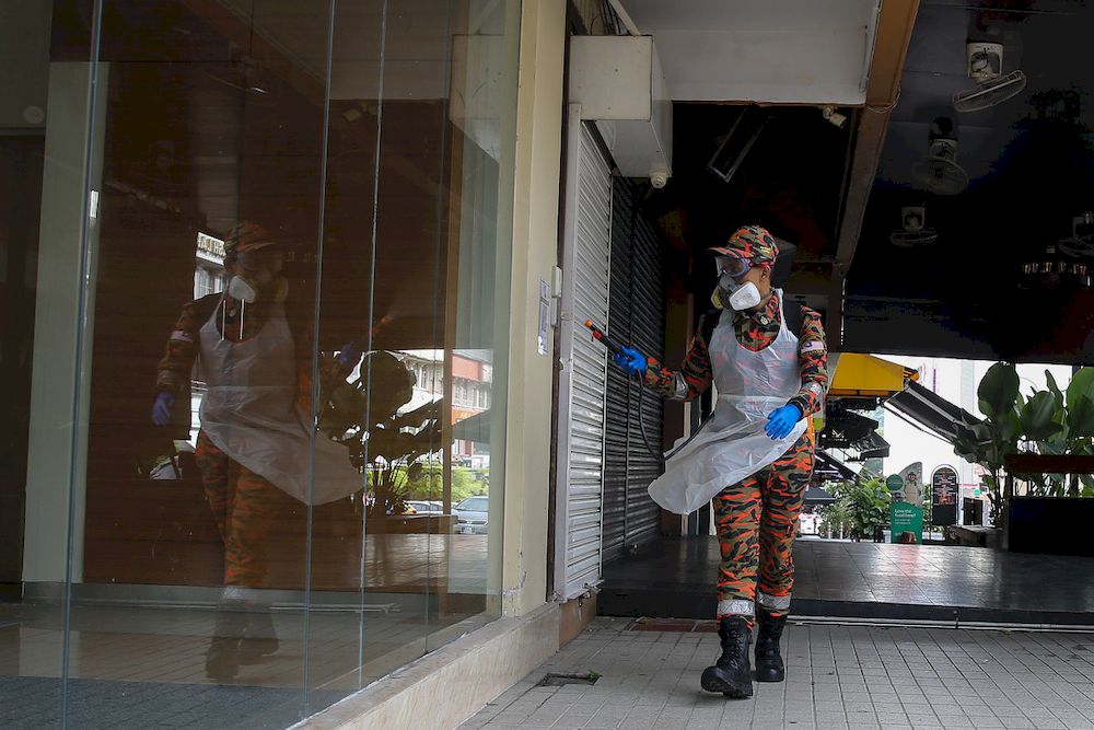 A firefighter spraying disinfectant at a business area during Movement Control Order phase at Bangsar in Kuala Lumpur January 23, 2021. u00e2u20acu201d Picture by Yusof Mat Isa