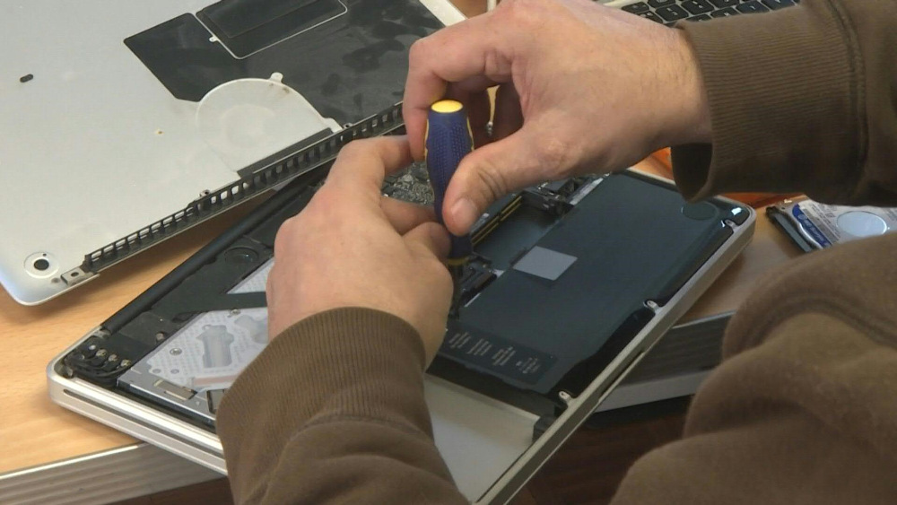 Volunteers sort through the laptops, prioritising ones that can be easily fixed while others are put to one side. u00e2u20acu201d AFP pic