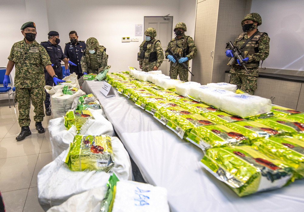 Eighth Brigade Commander Brig Gen Zamsari Abu Hassan (left) with the seized drugs at a press conference at Pasir Mas IPD, February 9, 2021. u00e2u20acu201d Bernama pic
