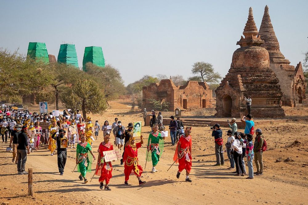 Protesters wearing traditional Bagan outfits hold signs as they take part in a demonstration against the Myanmar military coup in Bagan, a Unesco World Heritage site, on February 11, 2021. u00e2u20acu201d AFP pic