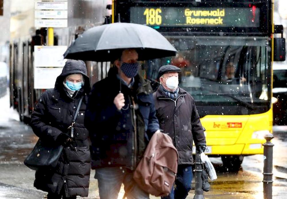 People wear face masks as they walk past a bus during lockdown due to the coronavirus disease (Covid-19) pandemic in Berlin, Germany, January 19, 2021. u00e2u20acu201d Reuters pic
