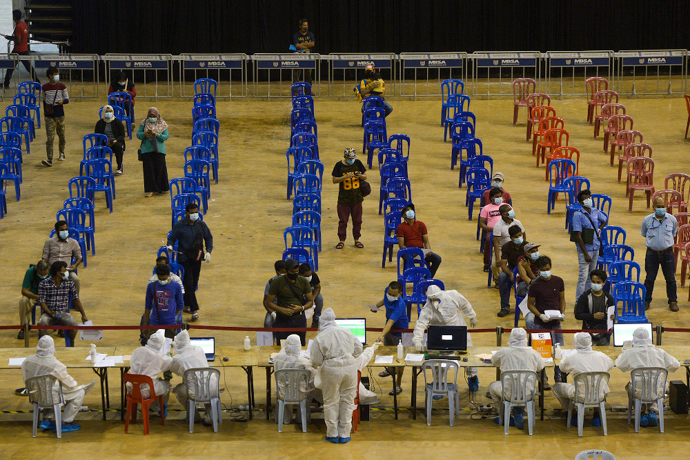 Patients gather at Covid-19 Assessment Centre (CAC) in Stadium Melawati Shah Alam February 8, 2021. u00e2u20acu201d Picture by Miera Zulyana