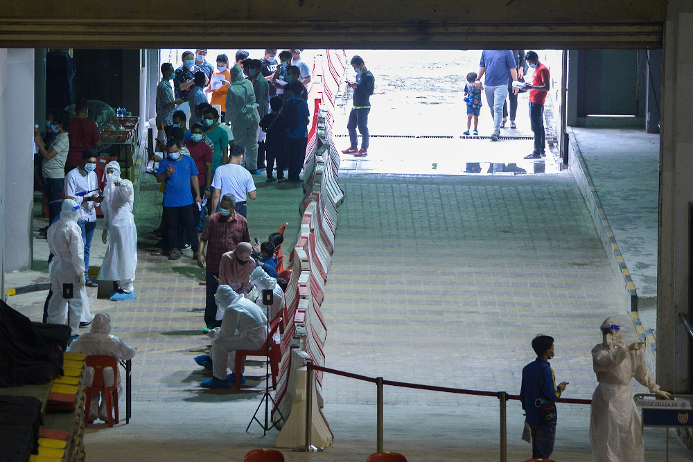 Patients gather at Covid-19 Assessment Centre (CAC) in Stadium Melawati Shah Alam February 8, 2021. u00e2u20acu201d Picture by Miera Zulyana
