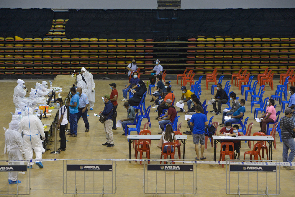 Patients gather at Covid-19 Assessment Centre (CAC) in Stadium Melawati Shah Alam February 8, 2021. u00e2u20acu201d Picture by Miera Zulyana