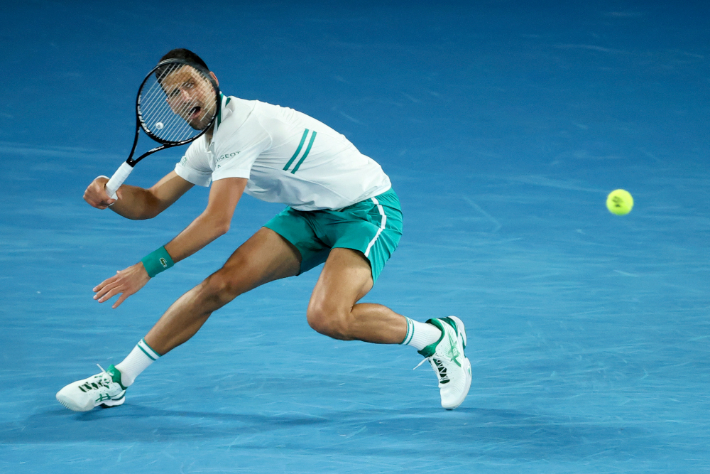Serbiau00e2u20acu2122s Novak Djokovic hits a return against Canadau00e2u20acu2122s Milos Raonic during their menu00e2u20acu2122s singles match on day seven of the Australian Open tennis tournament in Melbourne February 14, 2021. u00e2u20acu201d AFP pic
