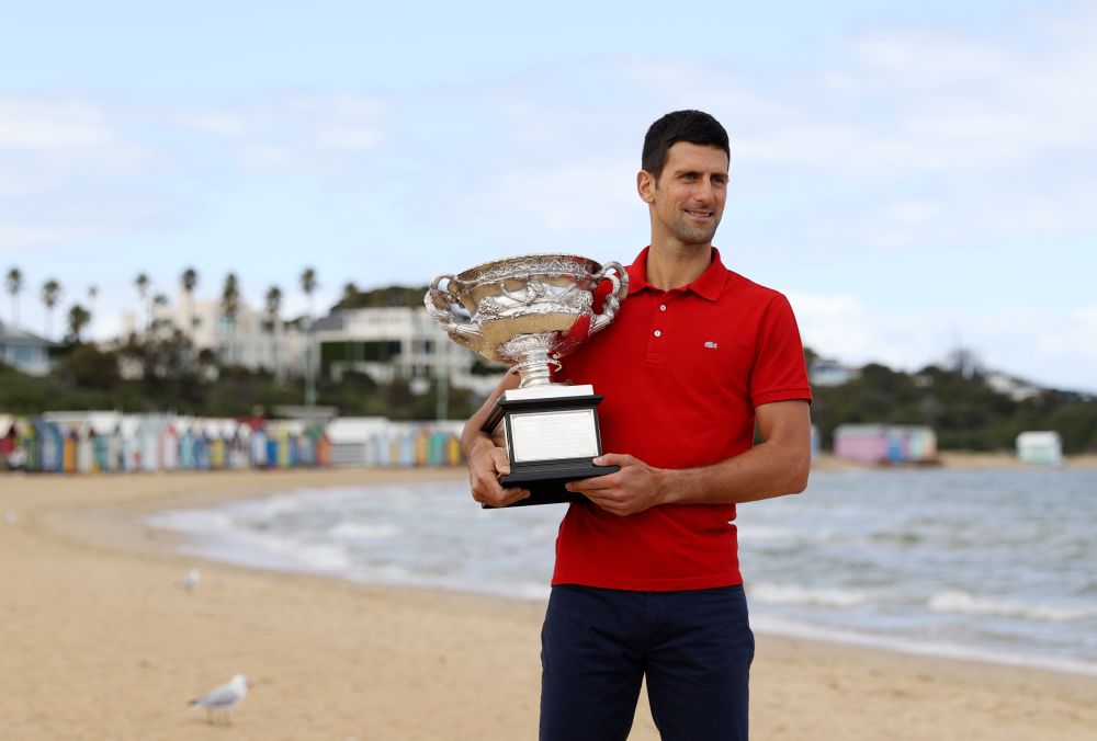 Australian Open champion Serbia's Novak Djokovic poses with the trophy during a photo shoot at Brighton Beach, Melbourne February 22, 2021. u00e2u20acu201d Reuters pic