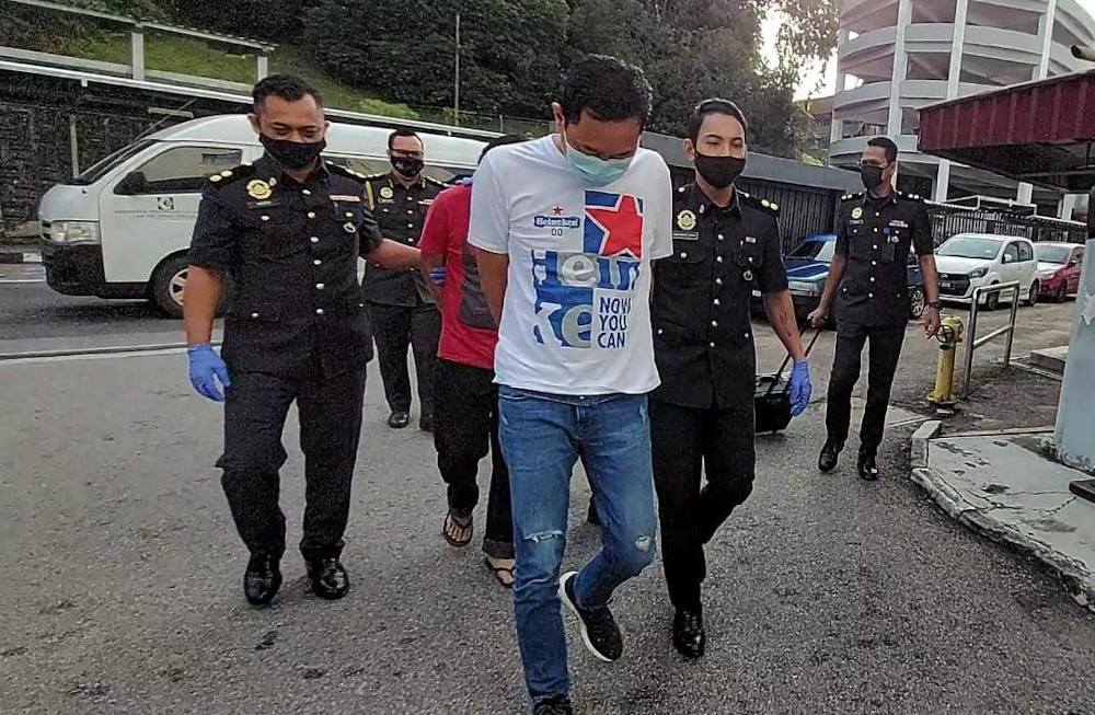 The company and two accused, as well as one who is still at large, are charged with using, possessing and offering 3,418 boxes of frozen food using false trade descriptions without approval at the Sessions Court in Johor Baru February 9, 2021. u00e2u20acu201d Picture