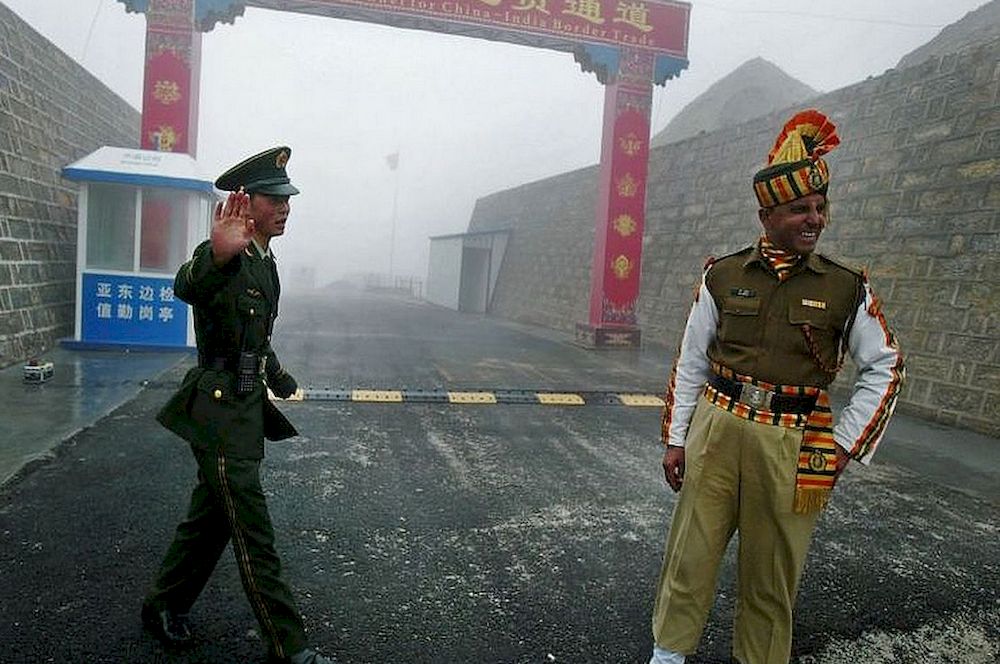 A Chinese soldier stands next to an Indian soldier at a border crossing between India and China. u00e2u20acu201d AFP pic