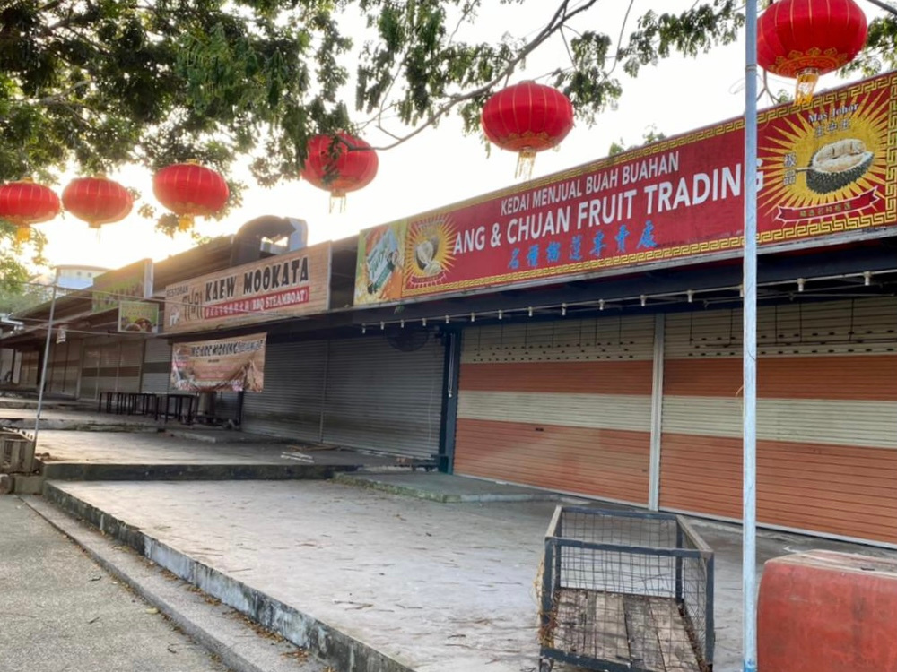 This row of shops including a popular fruit and snack shop near Sutera Mall in Skudai has been closed since the start of the MCO. — Picture by Ben Tan