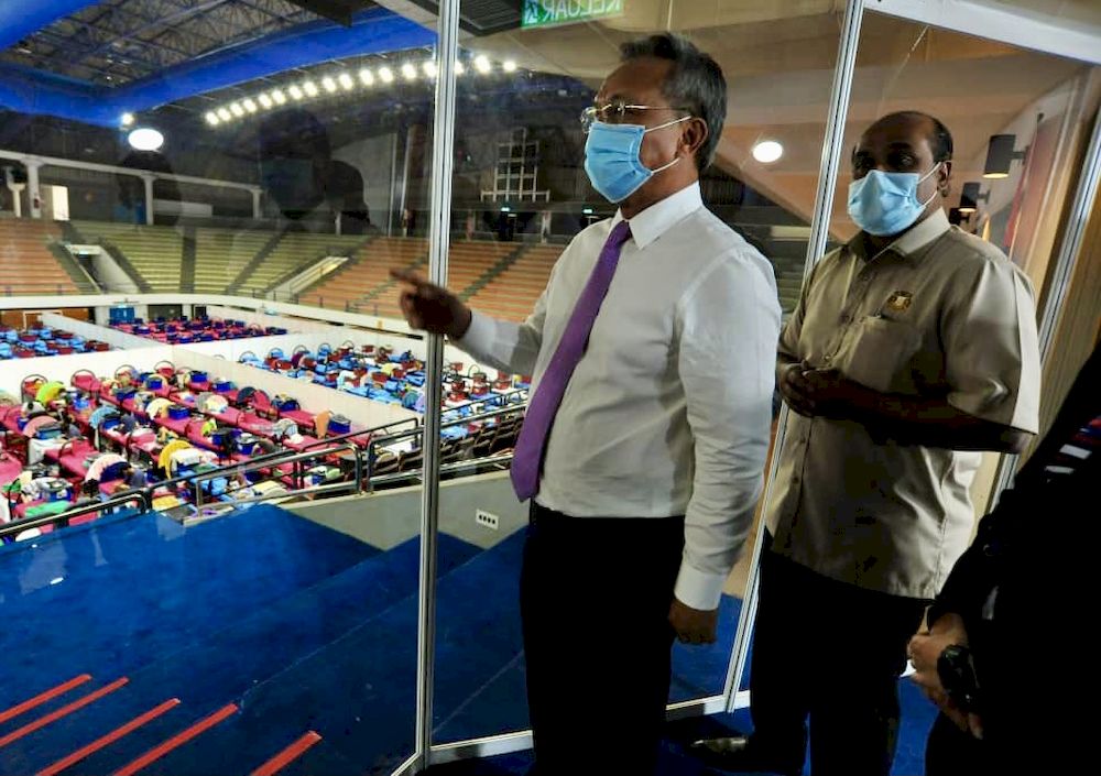 Johor MB Datuk Hasni Mohammad (left) and Johor Health and Environment Committee chairman R. Vidyananthan on their visit to the Covid-19 Quarantine and Treatment Centre at the Pasir Gudang City Council Indoor Stadium today. u00e2u20acu201d Picture by Ben Tan