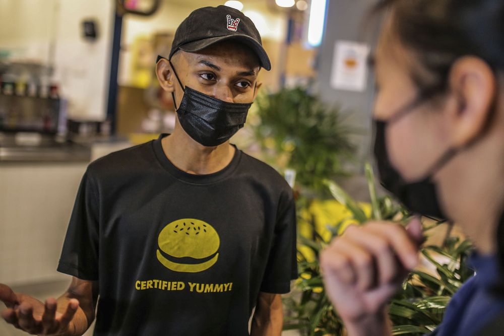 MyBurgerLab and Inside Scoop outlet supervisor Haqqem Zainal speaks to Malay Mail during an interview at the MyTown shopping centre in Kuala Lumpur February 10, 2021. — Picture by Hari Anggara