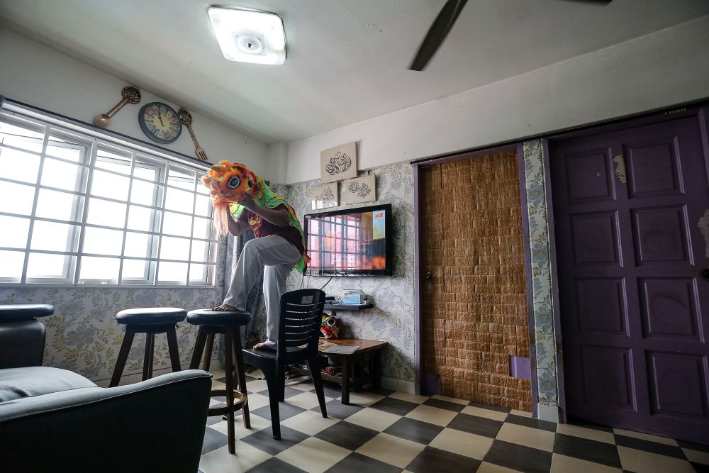 Mohd Fakhri Ruzaini practices his lion dance moves at home in Flat Medan Tengku, Jelutong February 11, 2021. 