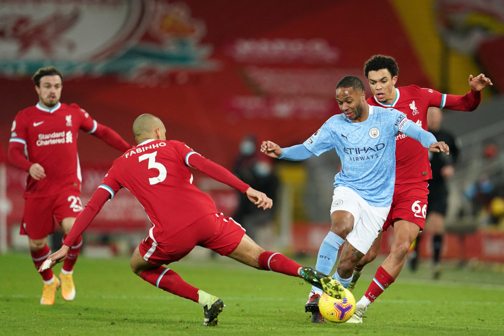 Manchester City midfielder Raheem Sterling vies with Liverpool midfielder Fabinho (2nd left) and defender Trent Alexander-Arnold during the English Premier League football match at Anfield in Liverpool, February 7, 2021. u00e2u20acu201d AFP pic