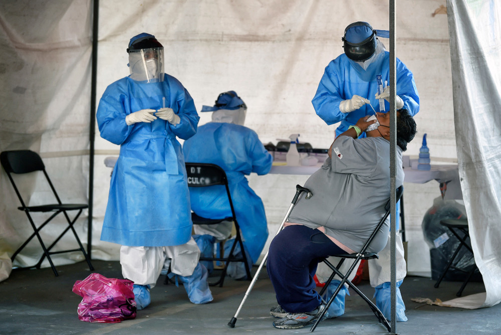 Health workers perform a Covid-19 rapid antigen test at a temporary health tent in Mexico City, February 12, 2021. u00e2u20acu201d AFP pic  