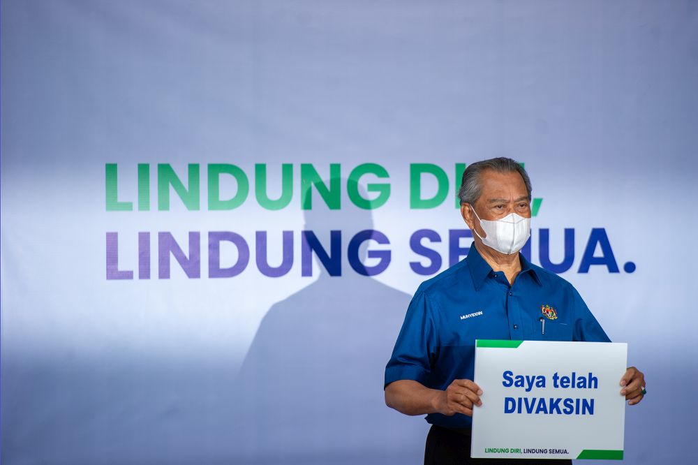 Prime Minister Tan Sri Muhyiddin Yassin poses for the cameras after receiving his jab during the launch of the National Covid-19 Immunisation programme in Putrajaya February 24, 2021. u00e2u20acu2022 Picture by Shafwan Zaidon