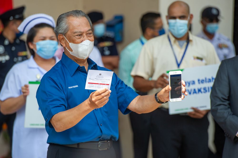 Prime Minister Tan Sri Muhyiddin Yassin poses for the cameras after receiving his jab during the launch of the National Covid-19 Immunisation programme in Putrajaya February 24, 2021. u00e2u20acu2022 Picture by Shafwan Zaidon
