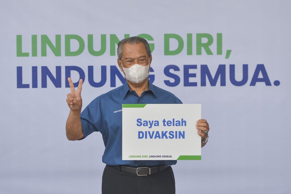 Prime Minister Tan Sri Muhyiddin Yassin poses for the cameras after receiving his jab during the launch of the National Covid-19 Immunisation programme in Putrajaya February 24, 2021. u00e2u20acu2022 Picture by Miera Zulyana