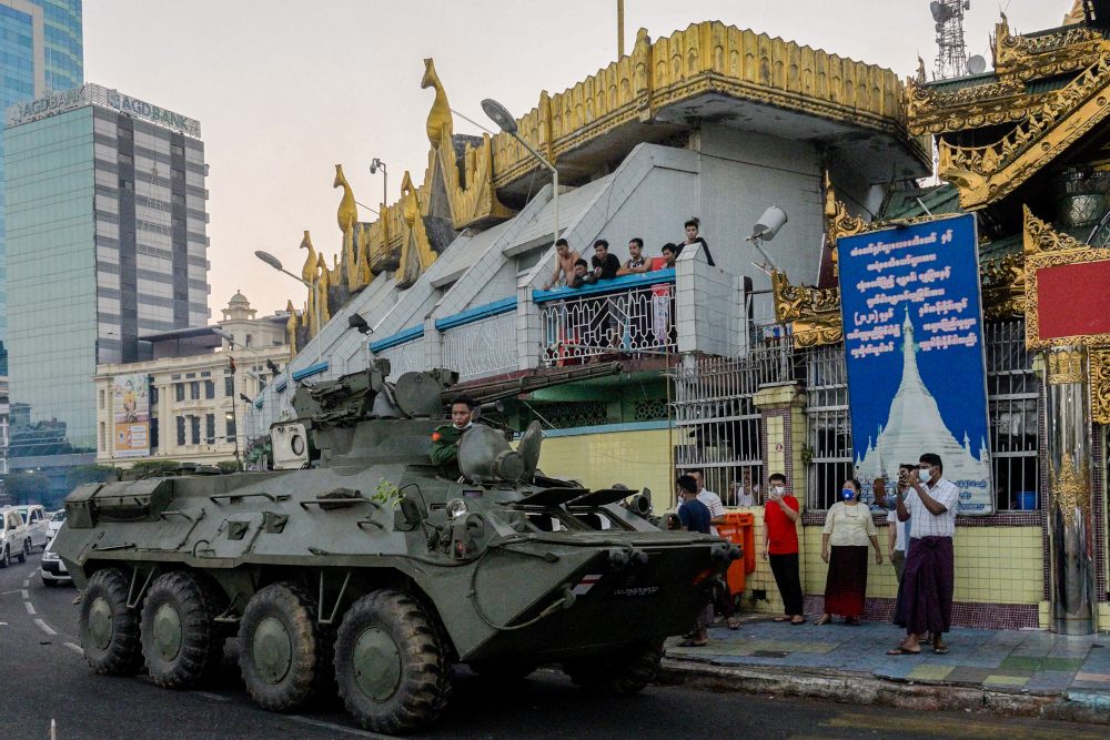 An armoured vehicle drives next to the Sule Pagoda, following days of mass protests against the military coup, in Yangon February 14, 2021. u00e2u20acu201d AFP pic 