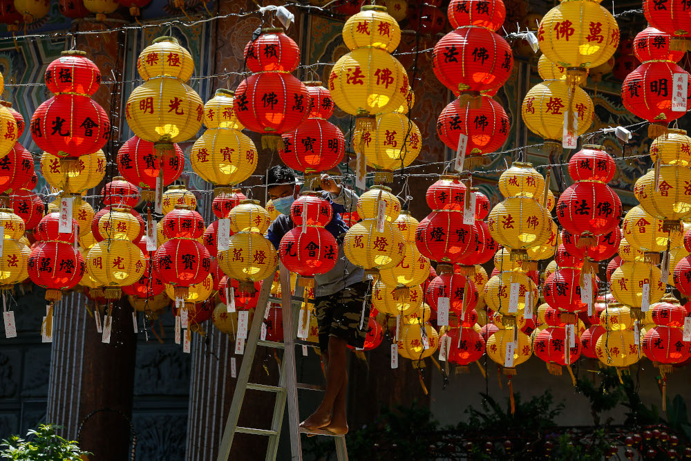 Workers seen wearing face masks as they touch up the ground with lanterns in conjunction with the upcoming Chinese New Year celebration at Kek Lok Si Temple, February 4, 2021. u00e2u20acu201d Picture by Sayuti Zainudin