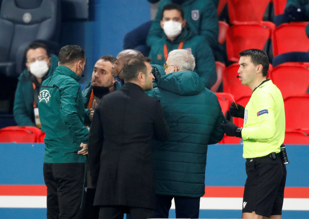 Fourth official Sebastian Coltescu with Istanbul Basaksehir assistant coach Pierre Webo and referee Ovidiu Hategan with Istanbul Basaksehir coach Okan Buruk as the match is interrupted at Parc des Princes, Paris December 8, 2020. u00e2u20acu201d Reuters pic