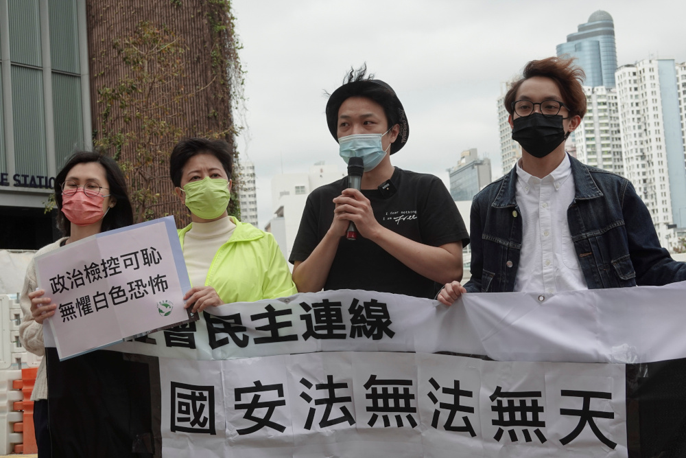 Pro-democracy activists Helena Wong Pik-wan (2nd left) and Jimmy Sham (2nd right) speak to the media as they arrive to report to the police station over national security law charges, in Hong Kong February 28, 2021. u00e2u20acu201d Reuters pic