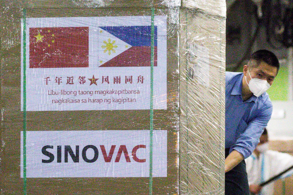 A worker unloads a box of Sinovac Biotechu00e2u20acu2122s CoronaVac Covid-19 vaccines from a Chinese military aircraft at Villamor Air Base in Pasay, Metro Manila February 28, 2021. u00e2u20acu201d Reuters pic