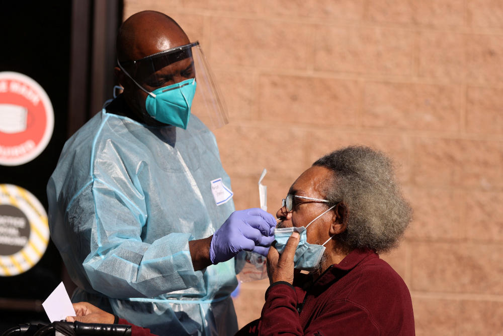 Nurse Marlon Stanford gives Dean Harper, 65, a coronavirus test at a Los Angeles Mission homeless shelter Thanksgiving meal giveaway, as the global outbreak of Covid-19 continues, in Los Angeles November 25, 2020. u00e2u20acu201d Reuters pic
