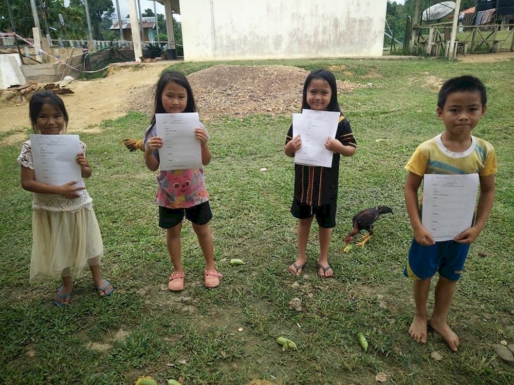 Some of the schoolchildren of Sungai Magandai with their schoolwork.