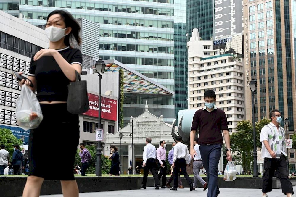 People walking during their lunch break at the financial business district of Raffles Place in Singapore on Jan 11, 2021. u00e2u20acu201d AFP pic