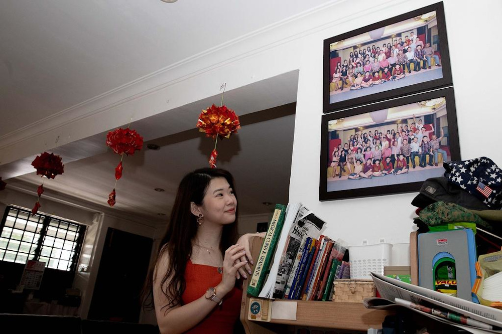 Financial advisor Sherrill Gan with framed photographs of her family from Singapore and Muar, Malaysia. u00e2u20acu201d Picture by Ili Nadhirah Mansor/TODAY 