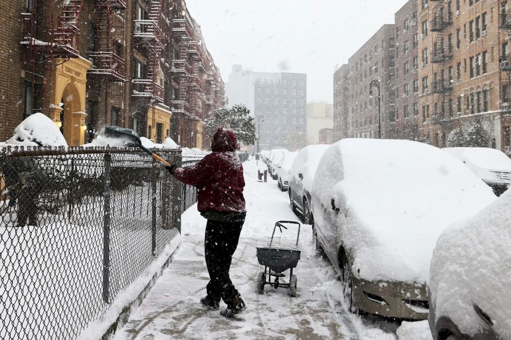 A man shovels snow off a sidewalk in the Flatbush neighbourhood of Brooklyn on February 01, 2021 in New York City. u00e2u20acu201dAFP pic
