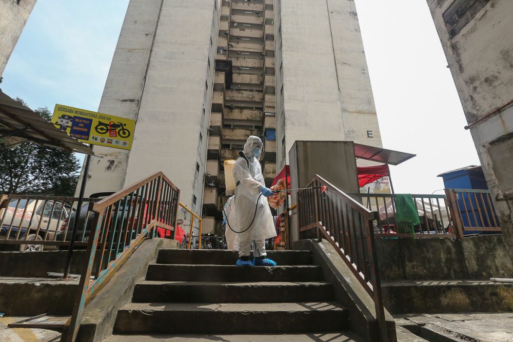 A Fire Dept personnel sprays disinfectant at the Lembah Subang 1 People Housing Project in Subang February 4, 2021. u00e2u20acu201d Picture by Yusof Mat Isa