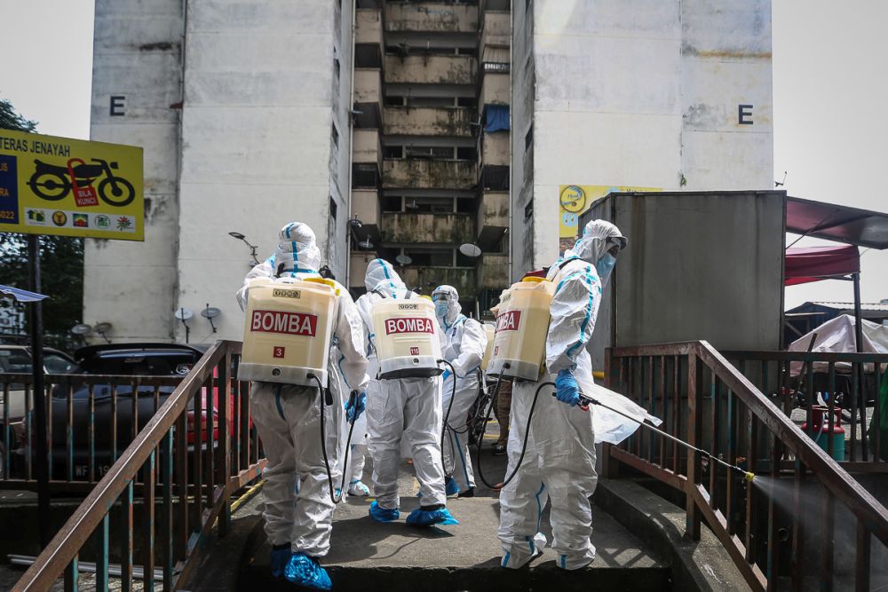 Fire Dept personnel spray disinfectant at the Lembah Subang 1 People Housing Project in Subang February 4, 2021. u00e2u20acu201d Picture by Yusof Mat Isa