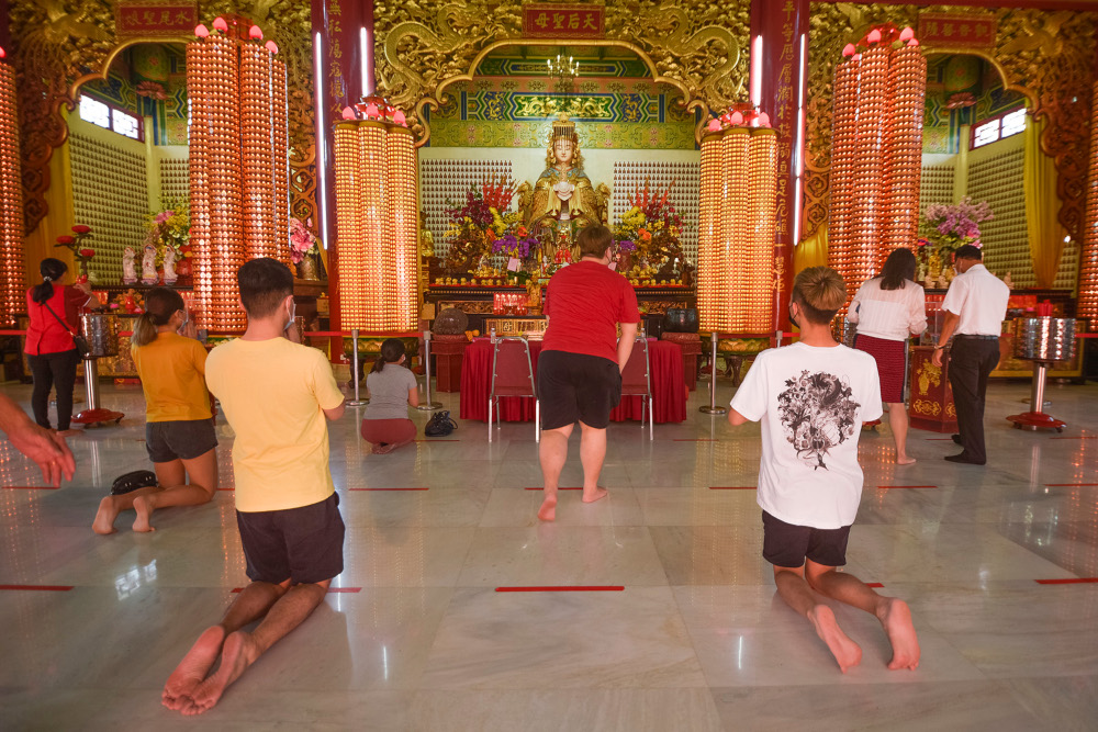 People wearing face masks attend prayers for Chinese New Year at Thean Hou Temple as the temple reopened in Kuala Lumpur on February 22, 2021. u00e2u20acu201d Picture by Miera Zulyana