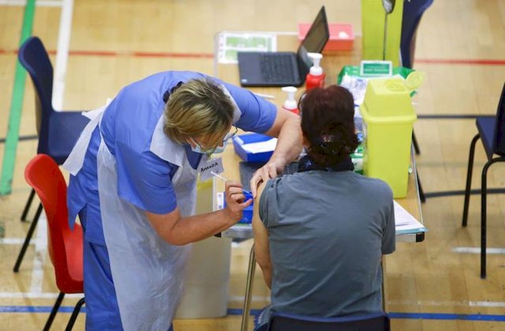 A woman receives an Oxford-AstraZeneca coronavirus disease (Covid-19) vaccine at a Covid-19 vaccination centre at Cwmbran Stadium in Cwmbran, South Wales, Britain February 17, 2021. u00e2u20acu201d Reuters pic