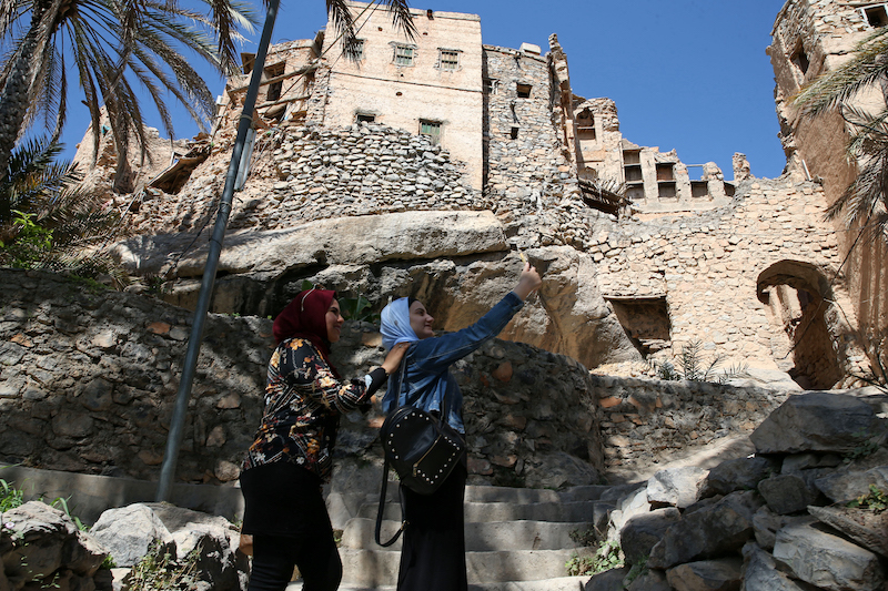 Egyptian tourists take a selfie as they tour the village of Misfat al-Abriyeen situated on the escarpments of Oman's Grand Canyon February 8, 2021. u00e2u20acu201d AFP pic
