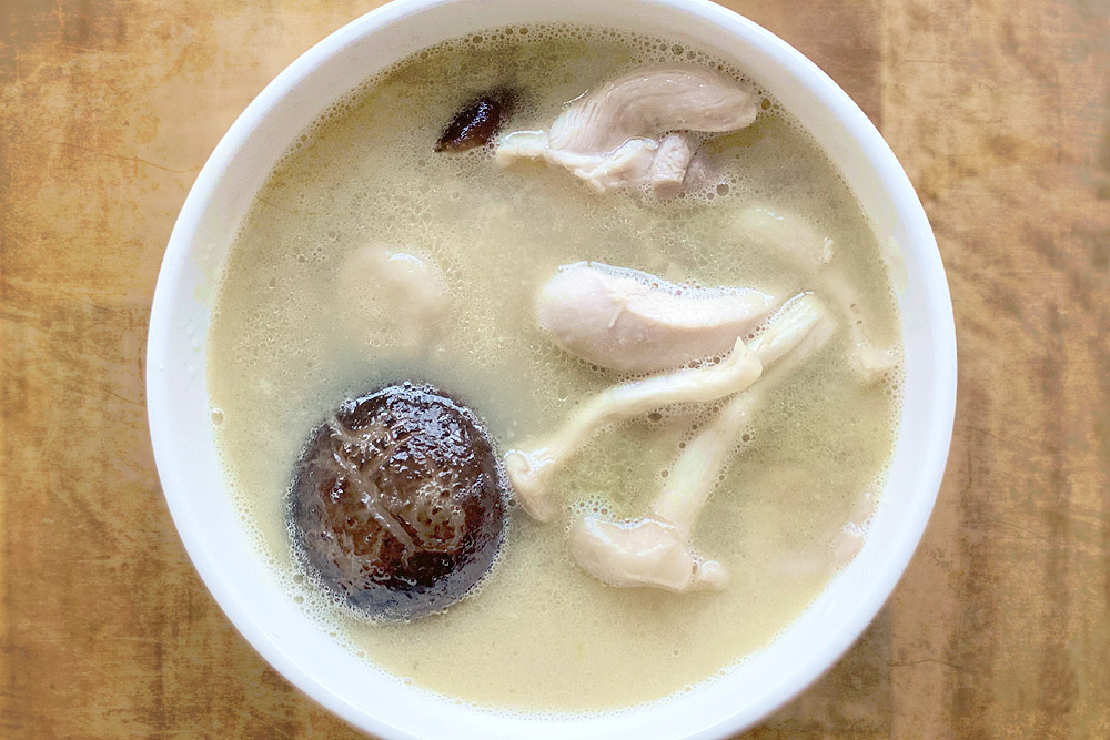 Ladle up some superior stock for use in a soup, adding fresh mushrooms and chicken.