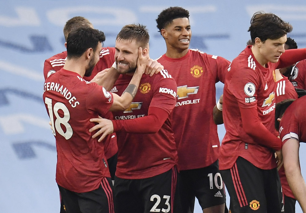 Manchester United's Luke Shaw celebrates scoring their second goal with teammates, March 8, 2021. u00e2u20acu201d Pool via Reuters/Peter Powell 