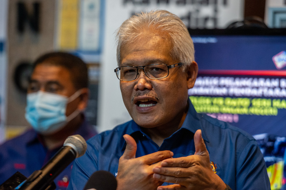 Minister of Home Affairs Datuk Seri Hamzah bin Zainudin speaks to the media during the launch of the Mobile National Registration Department bus at the National Registration Department in Putrajaya, March 18, 2021. u00e2u20acu201d Picture by Shafwan Zaidon